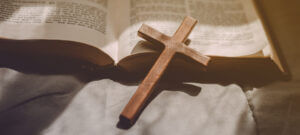 Crucifixion Of Jesus Christ ,cross With The Holy Bible At Sunlig